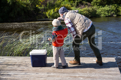 Happy man fishing with his son