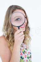Smiling woman holding magnifying glass