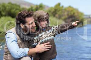 Happy casual father and son at a lake
