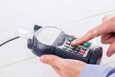 Man entering his pin on terminal