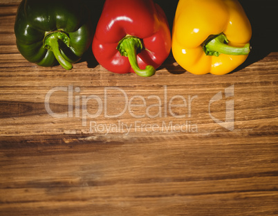 Three peppers on chopping board