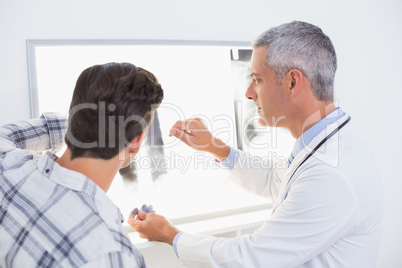 Doctor looking X rays with his patient