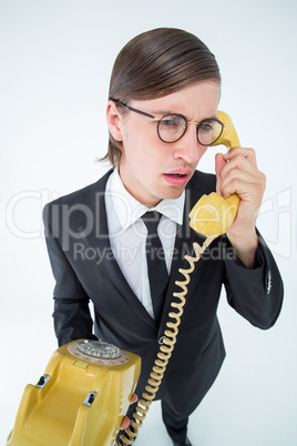 Focused geeky businessman on the phone