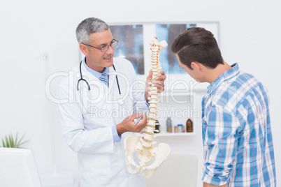 Doctor explaining the spine to his patient