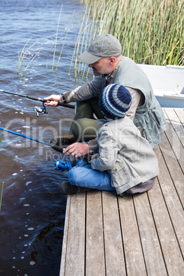 Father and son fishing at a lake