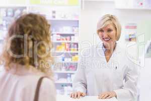 Pharmacist smiling at costumer
