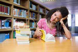 Pretty student studying in the library