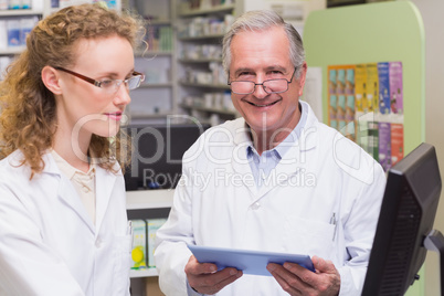 Team of pharmacists using laptop pc and computer