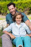 Father and son smiling at camera