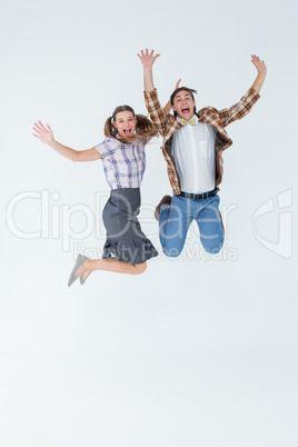 Geeky hipsters jumping and smiling