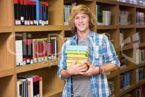 Student smiling at camera in library