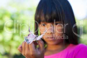 Cute little girl holding butterfly