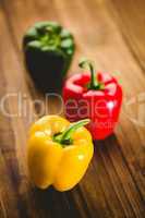 Three peppers on chopping board