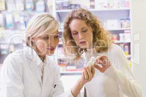 Pharmacist explaining something to a customer