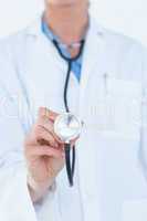 Confident female doctor holding stethoscope
