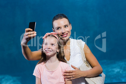 Happy mother and daughter taking selfie