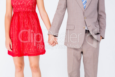 Hipster couple standing hand in hand