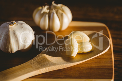 Garlic cloves and bulb on chopping board