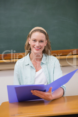 Teacher reading papers at her desk