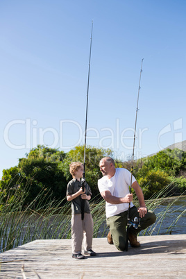 Happy man fishing with his son