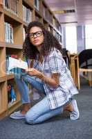 Student reading book in library