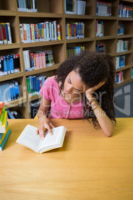 Pretty student studying in the library