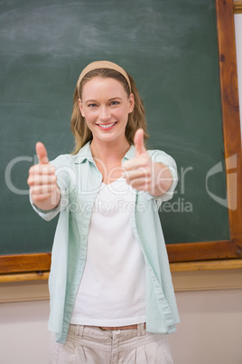 Teacher smiling at camera with thumbs up