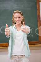 Teacher smiling at camera with thumbs up