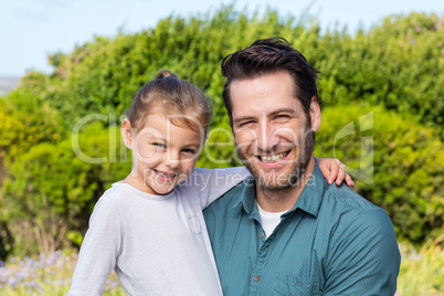 Father and daughter smiling at camera