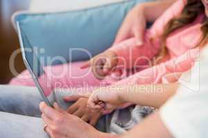 Family on the couch together using tablet pc