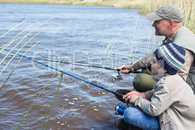 Father and son fishing at a lake