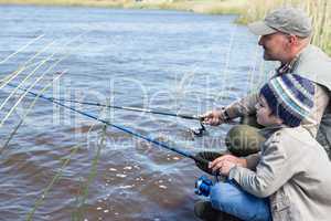 Father and son fishing at a lake