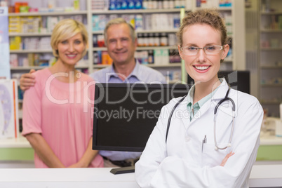 Pharmacist and costumers smiling at camera