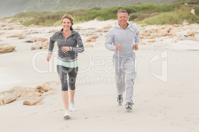 Fit couple jogging to camera