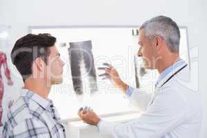 Doctor looking at X rays with his patient