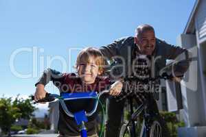 Happy father on a bike with his son