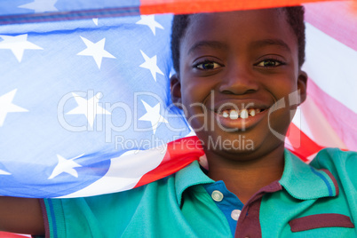 Happy boy in the park with american flag