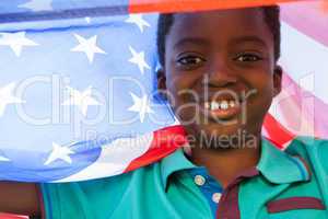 Happy boy in the park with american flag