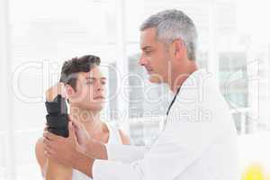 Doctor examining a man wrist