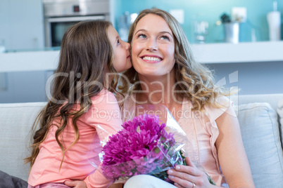 Daughter surprising mother with flowers