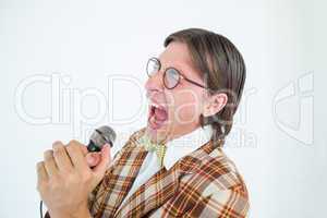 Happy geeky hipster singing with microphone