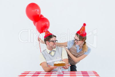 Geeky hipster couple celebrating his birthday