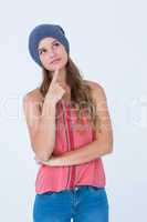 Thoughtful woman wearing hat with finger on chin