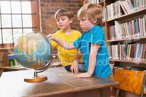 Cute pupils looking at globe