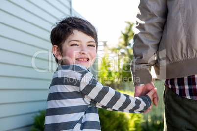 Father and son holding hands