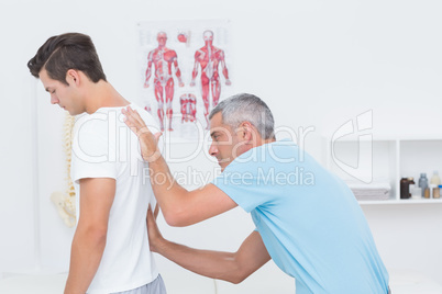 Doctor examining his patient back