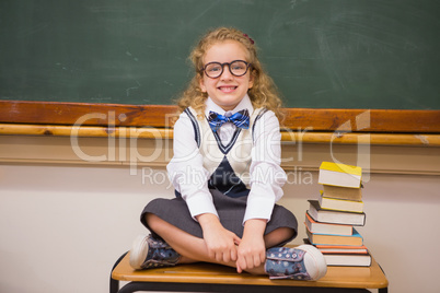 Cute pupil sitting on table