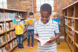 Pupils looking for books in library