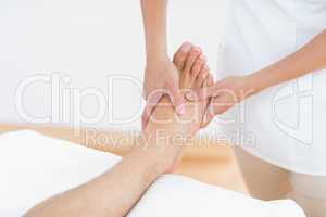 Physiotherapist doing foot massage