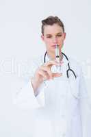 Doctor showing syringe to camera